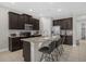 Modern kitchen with dark cabinetry, granite countertops, and stainless steel appliances at 365 Southfield St, Kissimmee, FL 34747