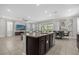 Open concept kitchen with dark cabinets, granite countertops, and an island at 365 Southfield St, Kissimmee, FL 34747