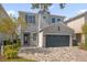 Two-story house with gray exterior and a paver driveway at 365 Southfield St, Kissimmee, FL 34747