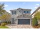 Beautiful two-story home with stone accents and a large driveway at 365 Southfield St, Kissimmee, FL 34747