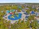 Aerial view of a community water park with slides, pools, and a playground at 365 Southfield St, Kissimmee, FL 34747