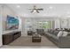 Open living space with sectional sofa, large TV, and access to backyard at 365 Southfield St, Kissimmee, FL 34747
