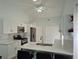 Modern kitchen with white cabinets, quartz countertops, and an island with seating at 4612 Cheyenne Point Trl, Kissimmee, FL 34746