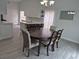 Dining room with a round table, six chairs, and a view into the kitchen at 4612 Cheyenne Point Trl, Kissimmee, FL 34746