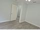 Bedroom with access to another room and wood-look floors at 4612 Cheyenne Point Trl, Kissimmee, FL 34746