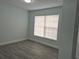 Spacious bedroom with gray wood-look floors and a large window at 4612 Cheyenne Point Trl, Kissimmee, FL 34746