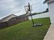 Grass backyard with basketball hoop and wooden fence at 4612 Cheyenne Point Trl, Kissimmee, FL 34746