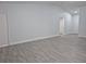 Bright living room with gray wood-look floors and a high ceiling at 4612 Cheyenne Point Trl, Kissimmee, FL 34746