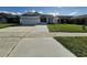 House exterior showing a one-story home with a two-car garage and well-maintained lawn at 4612 Cheyenne Point Trl, Kissimmee, FL 34746