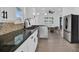 Modern kitchen with white cabinets, granite counters, and stainless steel appliances at 1020 W Line St, Leesburg, FL 34748