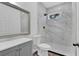 Modern bathroom with a large marble shower and grey vanity at 1020 W Line St, Leesburg, FL 34748