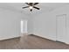 Spacious bedroom with wood-look floors and ceiling fan at 1020 W Line St, Leesburg, FL 34748