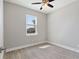 Bedroom with ceiling fan and large window at 1112 Nelson Meadow Ln, Kissimmee, FL 34759