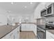 Modern kitchen with white cabinets, stainless steel appliances, and a large island at 11209 Listening Dr, Orlando, FL 32832