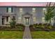 Two-story townhome with a stone accent and landscaped walkway at 11209 Listening Dr, Orlando, FL 32832