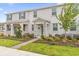 Two-story townhome with stone accents and landscaped front yard at 11209 Listening Dr, Orlando, FL 32832