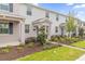 Row of townhomes showcasing stone accents and manicured landscaping at 11209 Listening Dr, Orlando, FL 32832