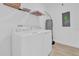 Laundry room with washer, dryer, and extra shelving at 11209 Listening Dr, Orlando, FL 32832