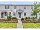 Two-story townhome with a stone accent and landscaped walkway at 11209 Listening Dr, Orlando, FL 32832