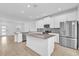 Modern kitchen with white cabinets, a large island, and stainless steel appliances at 11209 Listening Dr, Orlando, FL 32832