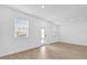Bright and airy living room with wood-look flooring and access to a private patio at 11209 Listening Dr, Orlando, FL 32832