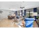 Open living area with a comfortable sectional sofa and dining table at 1430 Thunderbird Rd, Davenport, FL 33896