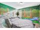 Unique bedroom with a stone bed and forest mural at 1430 Thunderbird Rd, Davenport, FL 33896