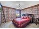 Bedroom with a bookcase-themed wall and a large bed at 1430 Thunderbird Rd, Davenport, FL 33896