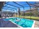 Relaxing screened-in pool area with patio at 1430 Thunderbird Rd, Davenport, FL 33896
