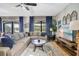Relaxing living room with sectional sofa, coffee table, and access to backyard at 1430 Thunderbird Rd, Davenport, FL 33896