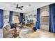 Cozy living area with comfortable seating, a large TV, and a charming decor at 1430 Thunderbird Rd, Davenport, FL 33896