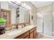 Bathroom with a double vanity and large mirror, rustic design at 1430 Thunderbird Rd, Davenport, FL 33896
