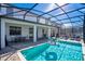 Relaxing pool area with covered patio and lounge chairs at 1430 Thunderbird Rd, Davenport, FL 33896