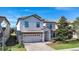 Two-story house with light-colored exterior, double garage, and landscaping at 1430 Thunderbird Rd, Davenport, FL 33896