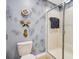 Bathroom with shower, toilet, and unique wall decor at 1430 Thunderbird Rd, Davenport, FL 33896