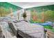Bedroom with stone bed frame and forest mural at 1430 Thunderbird Rd, Davenport, FL 33896