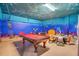 Fun game room with a pool table and ocean-themed decor at 1430 Thunderbird Rd, Davenport, FL 33896