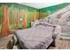 Bedroom with stone bed and forest mural at 1430 Thunderbird Rd, Davenport, FL 33896