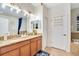 Double vanity bathroom with granite countertop, and a soaking tub at 1430 Thunderbird Rd, Davenport, FL 33896