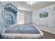 Unique bedroom with a custom-designed bed and icy blue mural at 1430 Thunderbird Rd, Davenport, FL 33896