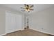 Bedroom featuring wood-look floors, ceiling fan, and double closet doors at 1533 Loch Avich Rd, Winter Garden, FL 34787