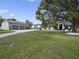 Spacious house exterior with large yard, detached garage, and mature tree at 20733 Oberly Pkwy, Orlando, FL 32833