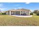 Large backyard with covered patio, fire pit, and plenty of grass at 2781 Sand Oak Loop, Apopka, FL 32712