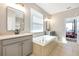 Bathroom with double vanity, soaking tub, and tile flooring at 2781 Sand Oak Loop, Apopka, FL 32712