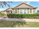 Tan house with white columns, manicured lawn, and walkway at 2781 Sand Oak Loop, Apopka, FL 32712