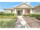 Tan house with walkway, manicured lawn, and American flag at 2781 Sand Oak Loop, Apopka, FL 32712