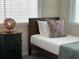 Twin bedroom with wood frame bed, nightstand and window coverings at 3161 Paradox Cir # 301, Kissimmee, FL 34746