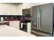 Modern kitchen features stainless steel appliances and white cabinetry at 3161 Paradox Cir # 301, Kissimmee, FL 34746