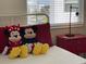 Bright bedroom with Mickey Mouse pillows and a red nightstand at 3161 Paradox Cir # 301, Kissimmee, FL 34746