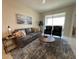 Living room features gray sofa and sliding glass doors at 3161 Paradox Cir # 301, Kissimmee, FL 34746